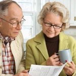 Elderly couple studying a document